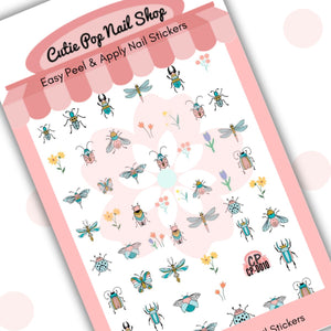 This image showcases Cutie Pop Nail Shop’s Bugs & Beetles nail decals against a white background with a Cutie Pop Nail Shop logo and watermark. Designs include a range of light-pink-and-blue insects including flies, beetles, damselflies, dragonflies, and May bugs, as well pastel-shaded yellow, red, and blue flowers.