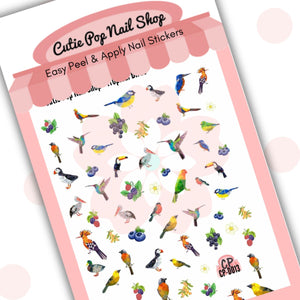 This image showcases Cutie Pop Nail Shop’s Tropical Birds nail decals against a white background with a Cutie Pop Nail Shop logo and watermark. The nail decal designs include a range of multi-colored, polygonal birds including cockatoos, parakeets, pelicans, toucans, blue tits, kingfishers, puffins, robins, and painted buntings, as well as white flowers, blueberries, grapes, white berries, and blackberries. 