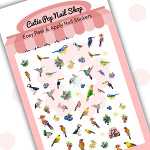 This image showcases Cutie Pop Nail Shop’s Tropical Birds nail decals against a white background with a Cutie Pop Nail Shop logo and watermark. The nail decal designs include a range of multi-colored, polygonal birds including cockatoos, parakeets, pelicans, toucans, blue tits, kingfishers, puffins, robins, and painted buntings, as well as white flowers, blueberries, grapes, white berries, and blackberries. 
